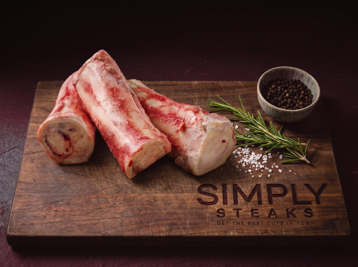 Three beef marrow bones on a Simply Steaks wooden board